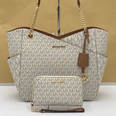 Michael Kors Large X Chain Shoulder Tote & Lg Flat Multifunctional Phone Case-Wristlet-Wallet Jet Set Large Logo Shoulder Bag Shoulder Bag Vanilla Signature Logo-Print Canvas 89.4% Coated Canvas/9.6% Polyester/1% Polyurethane Gold-Tone Hardware 15.6”W X 11”H X 5.5”D Handle Drop: 10" Exterior Details: Front Slip Pocket Interior Details: Back Zip Pocket, 2 Back Slip Pockets Lining: 100% Polyester Zip Fastening Imported & Lg Flat Multifunctional Phone Case Material: Leather/Pvc Removable Leather Wrist Strap Zip Around Closure Gold Tone Hardware Vanilla Signature Color Interior Cell Phone Pocket, Id Window, 6 Card Sl Pink Michael Kors Bag, Michael Kors Bag Brown, Black Tote Purse, Yellow Wallet, Yellow Tote Bag, Grey Shoulder Bag, Brown Tote Bag, Color Interior, Michael Kors Tote Bags