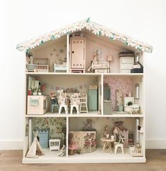 a doll house with furniture and accessories inside