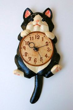 a black and white cat clock on the wall