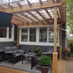 a covered patio area with furniture and an awning over the seating area on the deck