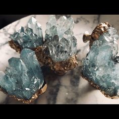 some very pretty blue and gold colored rocks on a white marble counter top or table