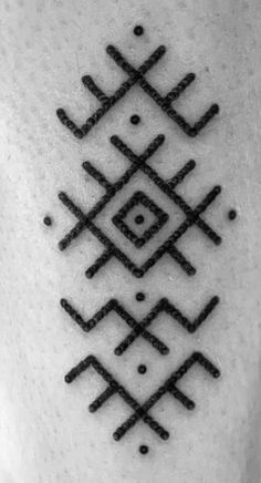 a black and white photo of an abstract tattoo design