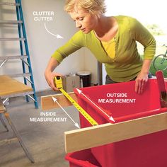 a woman standing next to a red box with measurements in it and labeled on the side