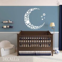 a baby's room with a crib and wall decal in the shape of a crescent