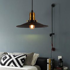 a bedroom with a bed, lamp and books