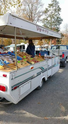 a food truck parked in a parking lot filled with lots of bread and pastries