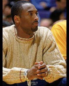 a man sitting on top of a basketball court