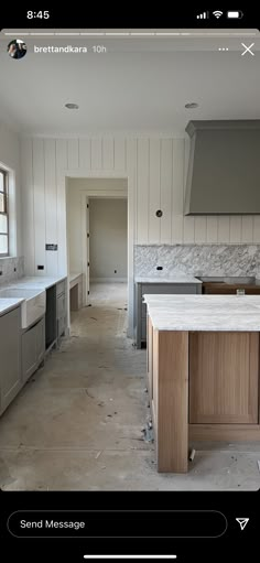 an image of a kitchen being remodeled with wood cabinets and marble counter tops on the island