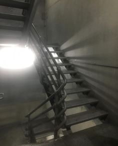 a set of stairs leading up to a bright light