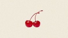 two cherries hanging from the side of a white wall