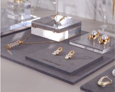 jewelry is displayed on display in glass cases, including earrings and necklaces with pearls