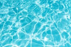 water ripples over the surface of a swimming pool