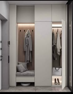 an open closet with some clothes hanging on the wall and shoes in the cupboards