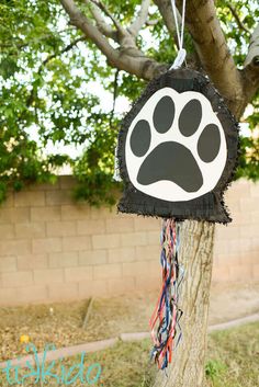 a dog paw decoration hanging from a tree