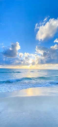 the sun is setting over the ocean with clouds in the sky and water on the beach