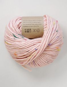 a ball of pink yarn with multicolored sprinkles