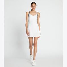 Carefully designed to optimize freedom of movement on the court, the cross-back dress introduces a new style to the tennis wardrobe. Fitted with an A-line silhouette and mini length, the lightweight dress features mesh side panels and a built-in unitard for support and coverage. Crafted in performance jersey — a technical fabric offering breathability and moisture wicking properties. Athleisure Mini Length Tennis Dress For Sports, Mini Length Tennis Dress For Workout, Sporty Tennis Dress For Summer, Sporty Spring Tennis Dress, Sporty Spring Dresses For Sports, Sleeveless Tennis Mini Dress For Spring, Sleeveless Mini Tennis Dress For Spring, Sporty Mini Tennis Dress For Workout, Summer Tennis Dresses In Athleisure Style