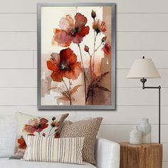 a living room scene with focus on the couch and wall art that has flowers painted on it