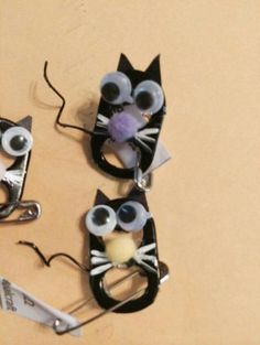 three black and white cats made out of scissors