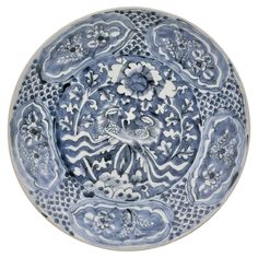 a blue and white plate with flowers on it