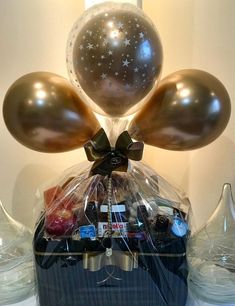 a basket filled with balloons and chocolates