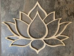 a wooden cutout of a lotus flower on a stone wall in the shape of a circle