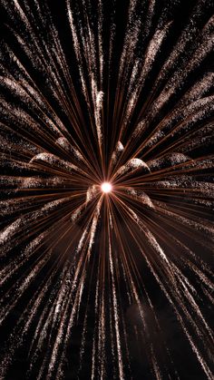 fireworks exploding in the night sky with bright lights on it's side and black background