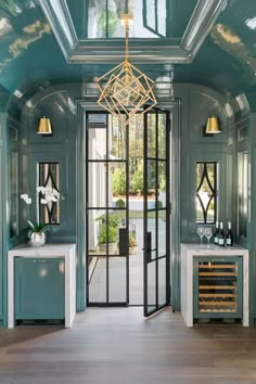 an instagramted photo of the inside of a house with blue walls and glass doors