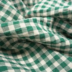 the green and white checkered fabric is folded up to show it's folds