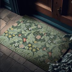 a door mat with flowers and leaves on it