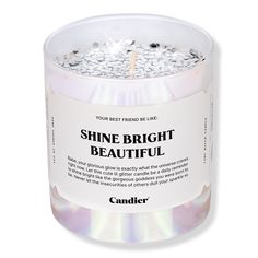 a candle that is sitting inside of a glass jar with the words shine bright beautiful on it