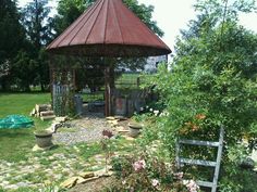 a small gazebo in the middle of a garden