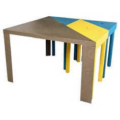 three tables with different colors and shapes on each one table is made out of concrete