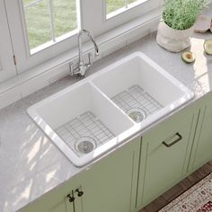 two white sinks sitting on top of a kitchen counter