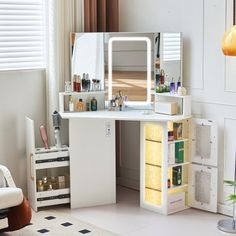 a white dressing table with drawers and a mirror