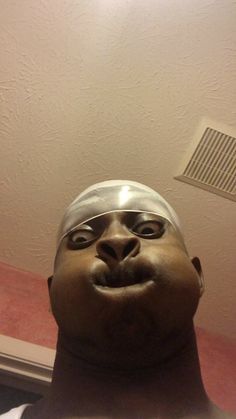 a man's head is shown in front of a ceiling fan