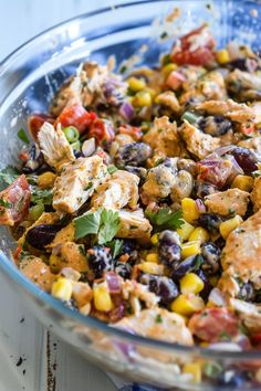 a glass bowl filled with chicken salad on top of a table