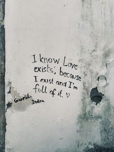 graffiti on the side of a building with words written in black and white, i know love exits because i exit and i'm full of it