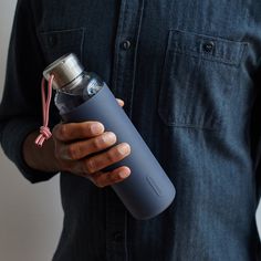 a man is holding a water bottle in his hand