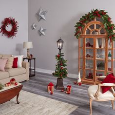 a living room filled with furniture and christmas decorations