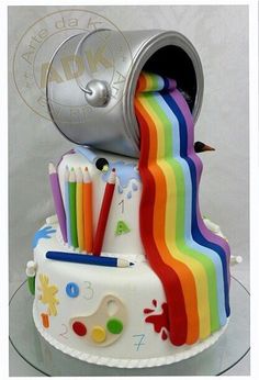 there is a cake that has been decorated with rainbows and pencils on it