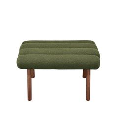 the footstool is made from wood and has green upholstered fabric on it