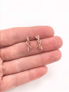 14k Rose Gold DNA Earrings DNA Jewelry DNA Climbers Biology Science Twist Earrings Double Helix Biologist Gift Doctor Gift Science GiftThis DNA earrings is a must for a Biologist, a Doctor or a Nurse, bringing your habit to one more science level in your life and satisfy your nerdy needs!Comes on a beautiful display card ready for gift giving. Add a woven gift bag with a hand tied ribbon and box at checkout!Earrings: 14K Gold Filled or 14k Gold Finish or Sterling Silver or Rhodium (Silver) Finis Nursing Earrings, Biology Earrings, Dna Earrings, Biology Jewelry, Dna Jewelry, Secret Sister Gifts, Biology Science, Tied Ribbon, Twist Earrings