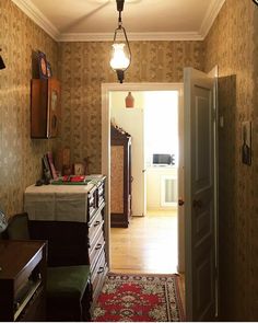 an open door leading into a room with a rug on the floor and other furniture