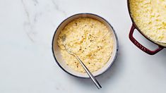 there is a bowl of food with a spoon in it and another bowl next to it