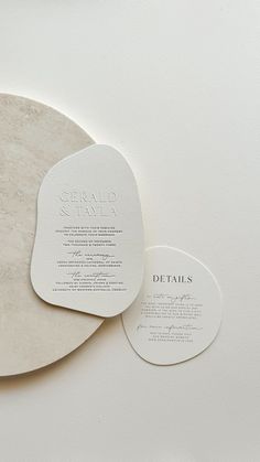 two circular coasters sitting on top of a white countertop next to each other