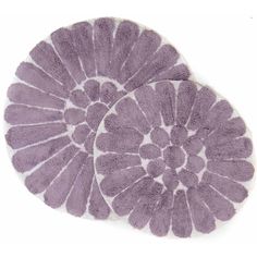 two circular rugs in purple and white on a white background