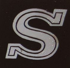 the letter s is painted with white paint and water droplets on it's surface