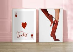 two framed posters on the wall in front of pink walls with red shoes and hearts