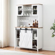 a white cabinet with wine glasses and bottles